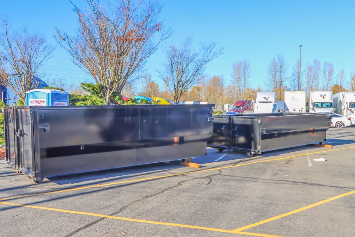 Professional dumpster rental service with roll-off container on residential driveway in Laguna Beach